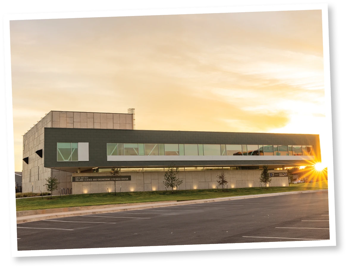 Exterior of the Gayle and Max Dillard Science and Engineering Research Center at Abilene Christian University, shown at sunset with modern architecture and an empty parking lot in front.