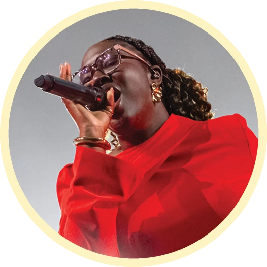 Student performs on stage with a microphone.