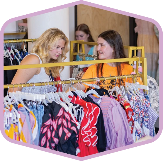 Students browse clothing at a local shop.