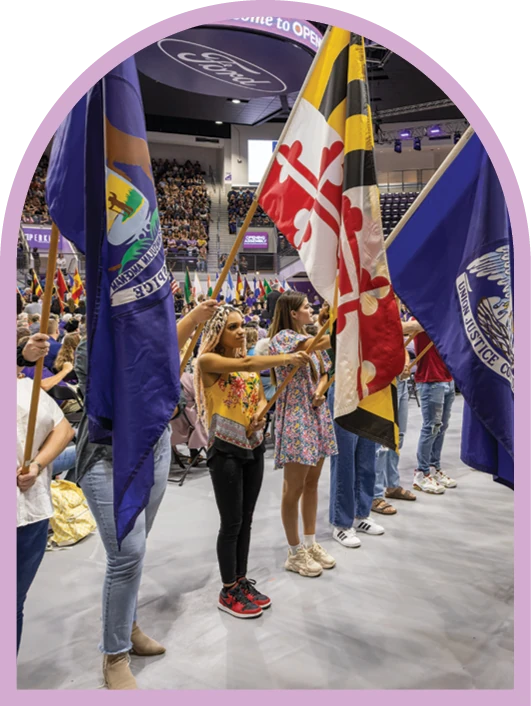 Students carrying flags during ACU’s Parade of Flags tradition.