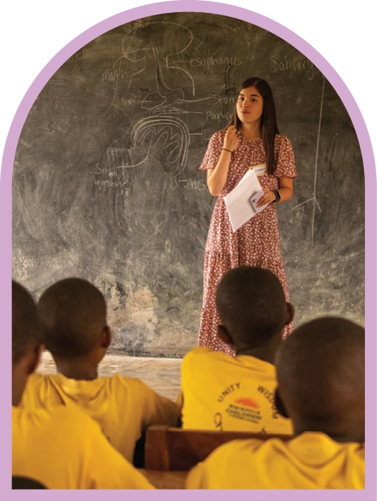 Student teaching children during an ACU mission trip.