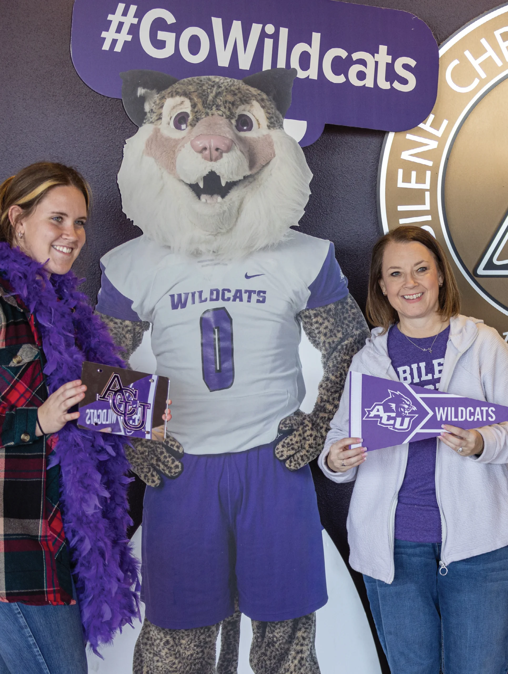Students pose with Willie the Wildcat mascot at an ACU event.